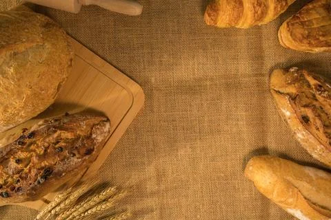 Assortment of bread and wheat on burlap. Healthy food, traditional craft br.. Stock Photos