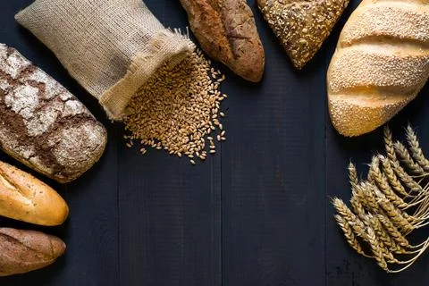 Assortment of bread on dark background. Stock Photos