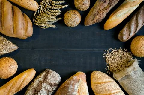 Assortment of bread on dark table. Stock Photos