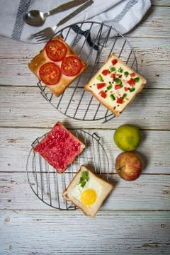 Assortment of bread with jam, cheese, egg and tomato with condiments Stock Photos