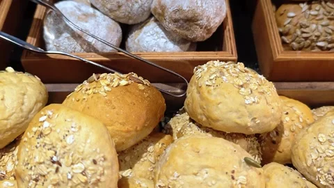 Assortment of  bread rolls served in a basket for breakfast buffet at hotel. Stock Footage 314889373