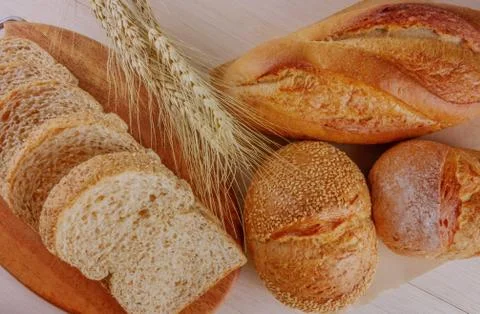 Assortment of breads on wooden table Stock Photos