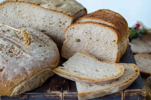An assortment of breads on wooden table. Stock Photos