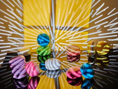 An assortment of bright macarons of different colors is displayed on a glass  Stock Photos