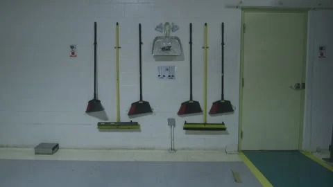 Assortment of Brooms Hanging on a Wall Stock Footage 139313455