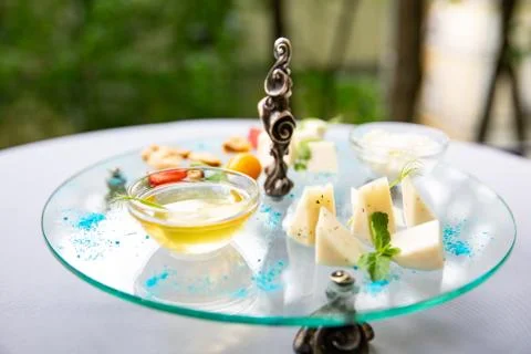 Assortment of cheese. Composition of different varieties of cheese with honey Stock Photos