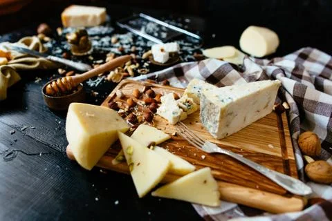 Assortment of cheese. Composition of different varieties of cheese with honey Stock Photos