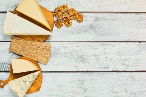 Assortment of cheese with walnuts and crisps Stock Photos