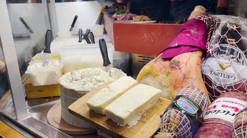 Assortment of cheeses and cold cuts displayed at a deli counter Stock Footage 259340298