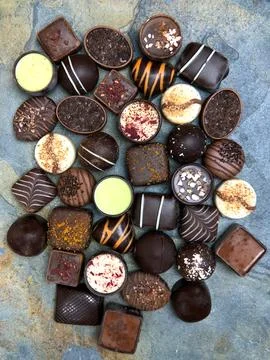 Assortment chocolates on stone background Stock Photos