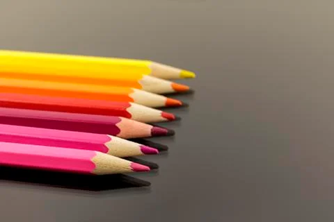 Assortment of colored pencils in a stack in shallow focus on balck background Stock-Fotos