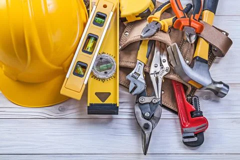 Assortment of construction tools Leather tool belt Construction helmet on Foto stock
