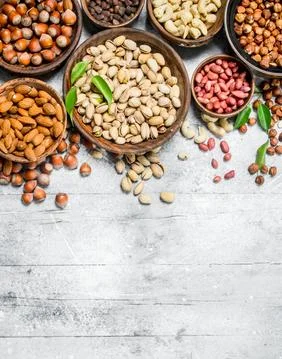 Assortment of different nuts in bowls. Stock Photos