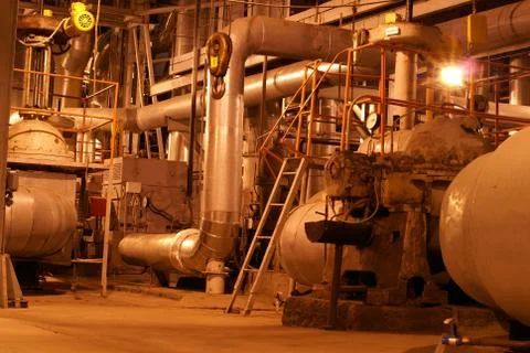An assortment of different size and shaped pipes at a power plan Stock Photos