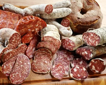 Assortment of different sliced salamis Stock Photos