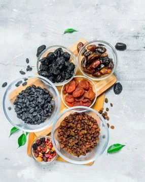 Assortment of different types of dried fruits in bowls. Stock Photos