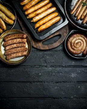 Assortment of different types of fried sausages. Stock Photos