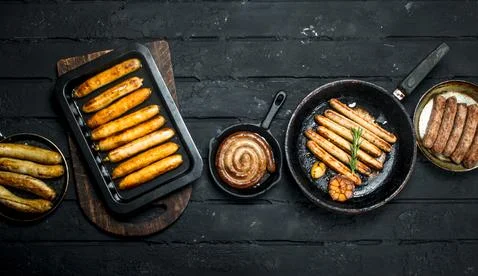 Assortment of different types of fried sausages. Stock Photos