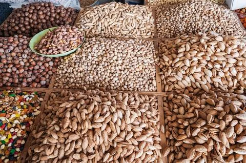 Assortment of different variety nuts and dried fruits on counter at eastern Stock Photos
