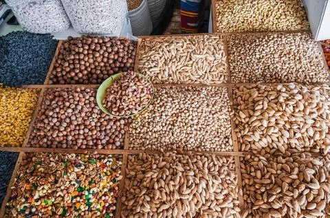Assortment of different variety nuts, dried fruits on counter at oriental food Stock Photos