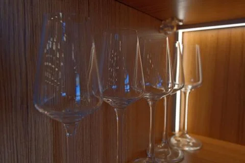 Assortment of Empty Glasses on Rustic Wooden Shelf in Bar. Stock Photos
