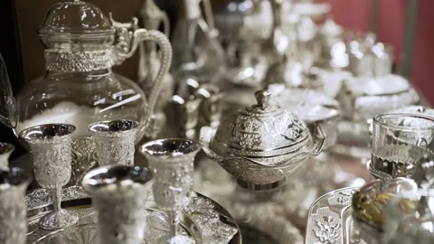 An assortment of festive silver tableware is presented in the shop window. Stock Footage 276828378