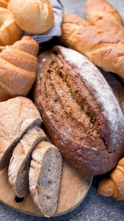 Assortment of fresh baked bread on a rustic table Stock Footage 335871383