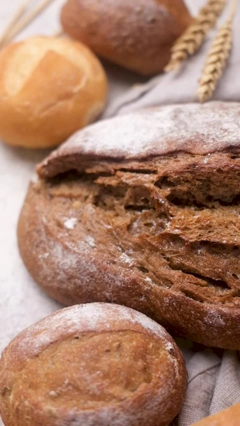 Assortment of fresh baked bread with wheat ears Stock Footage 336307919