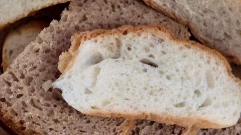 Assortment of Fresh Sliced Bread and Artisan Buns in a Wicker Basket for Pa.. Stock Footage 328451493