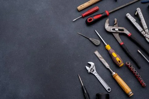 Assortment of Hand Tools on Dark work Background. Equipment implement Stock Photos