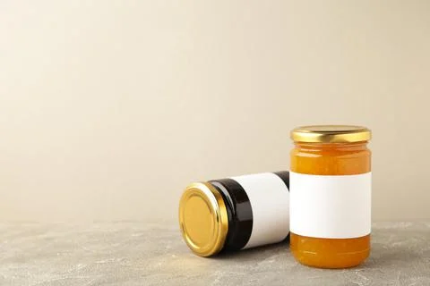 Assortment of jam jars mock-up. Jars with blank label on grey Stock Photos
