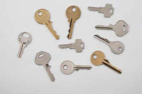 Assortment of keys on plain background Stock Photos