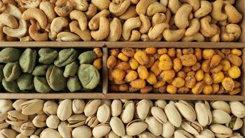 Assortment of mixed nuts and seeds in a wooden box Stock Footage 339366991