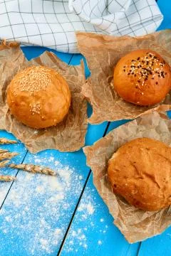 Assortment of multi-grain bread rolls on on blue wooden table Stock Photos