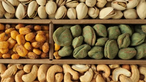 Assortment of nuts and salty snacks Stock Footage 335836543