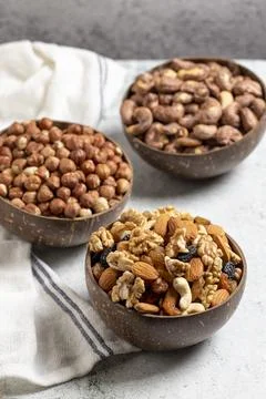 Assortment of nuts on a gray background. Hazelnuts, walnuts and mixed nuts in Stock Photos