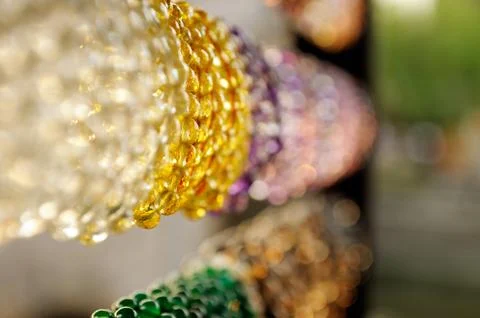 An assortment of openwork transparent bangles , saturated colors hanging in t Stock Photos