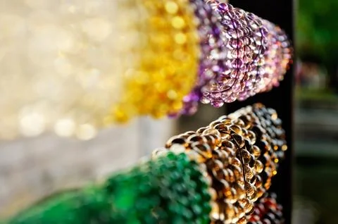 An assortment of openwork transparent bangles , saturated colors hanging in t Stock Photos