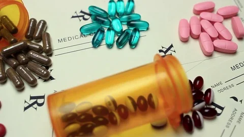 Assortment of pills on top of Prescriptions Stock Footage 73025057