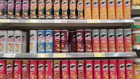 Assortment of Pringles potato chips on counter shelf. Stock Footage 291240343