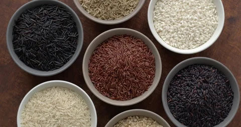 Assortment of rice grains, top view, table spin. Video stock 278514205
