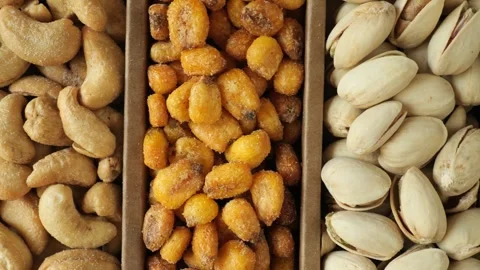 Assortment of roasted nuts and salted corn Stock Footage 336038118
