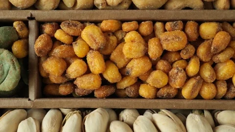 Assortment of roasted nuts and snacks moving slowly Stock Footage 336038194
