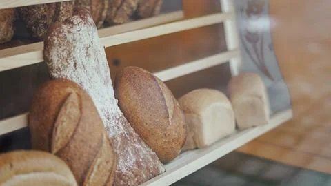 Assortment of rustic artisan loaves displayed in a bakery shop Stock Photos