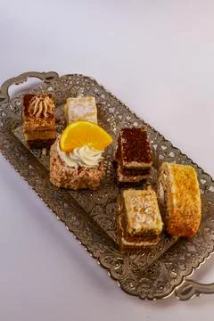 Assortment of six bite-sized cake varieties including layered sponge slices Stock Photos