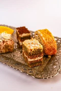Assortment of six bite-sized cake varieties including layered sponge slices Stock Photos