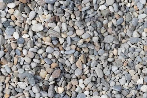 Assortment of smooth natural river rock pebbles creating a background Stock Photos