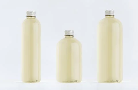Assortment of three plastic tall, low and thick bottles with pale fresh drink Stock Photos