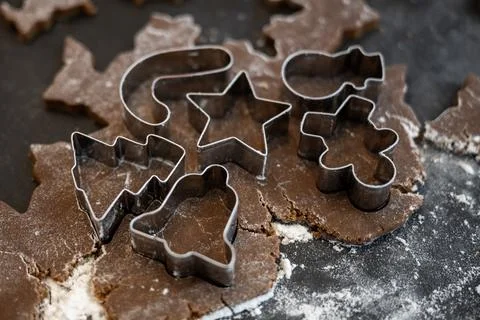 Assortment of Tiny Cookie Cutters Pressed into Gingerbread Dough Photos