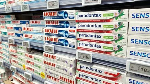 Assortment of toothpaste on a shelf in a store Stock Photos